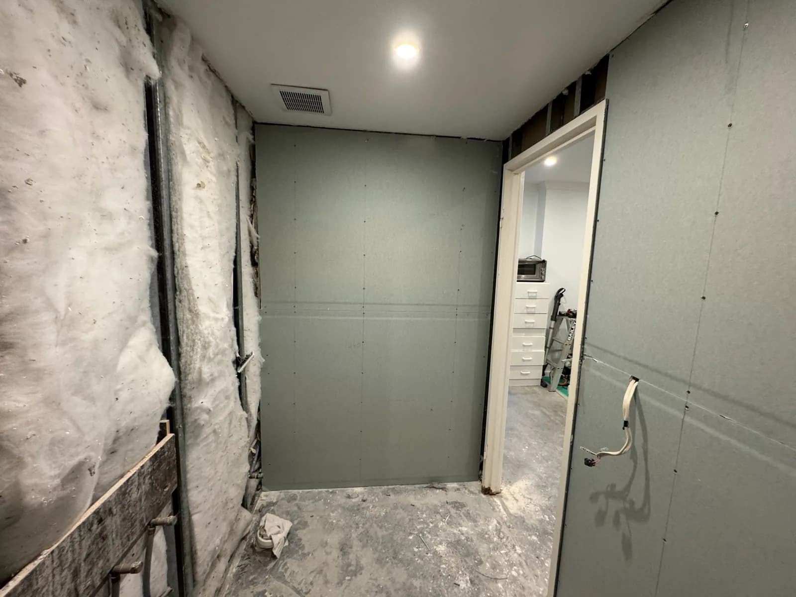 New wall sheeting installed over the frame in a bathroom rebuild
