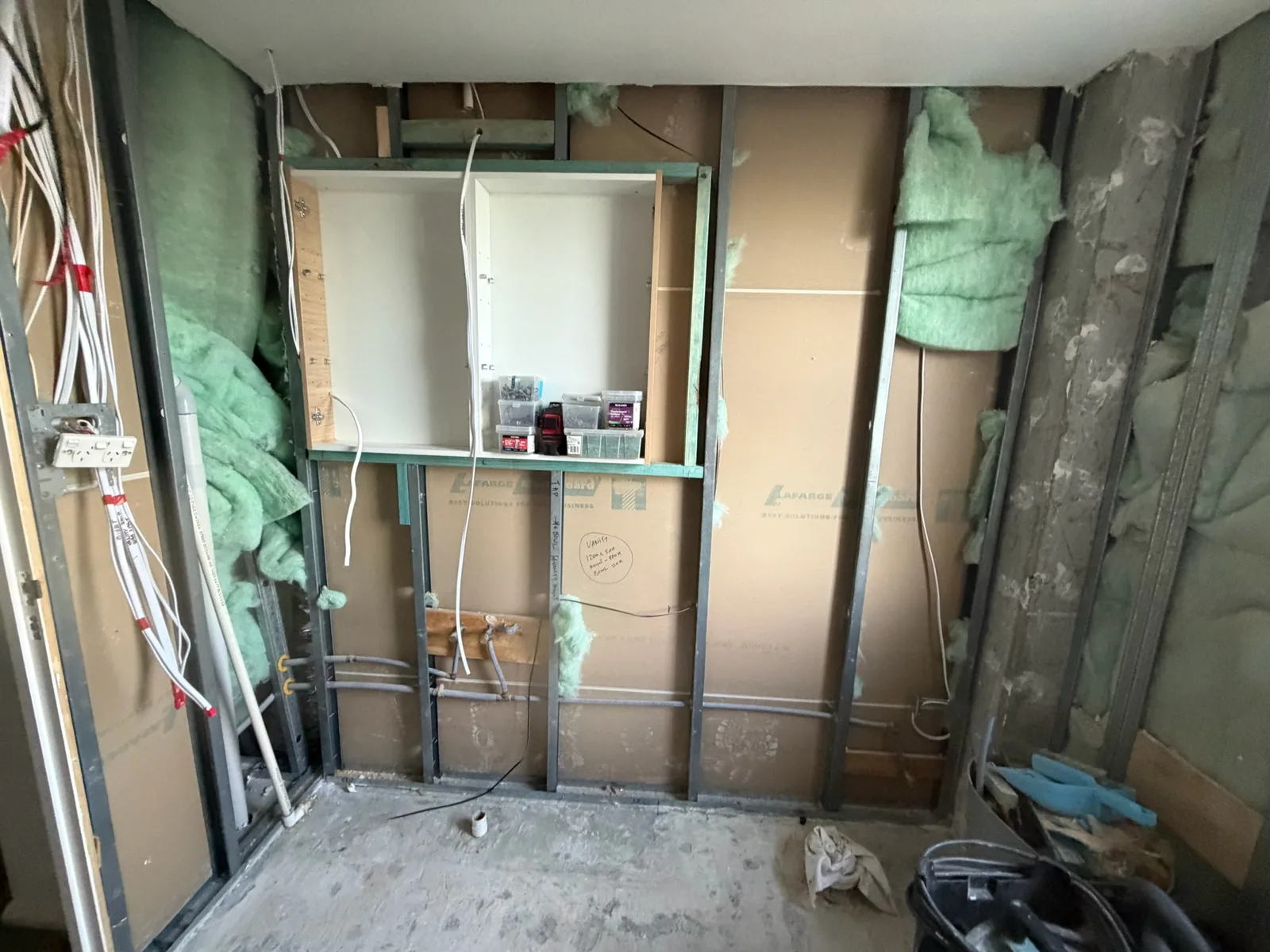 Wall frame with a shower niche framed up and services roughed in