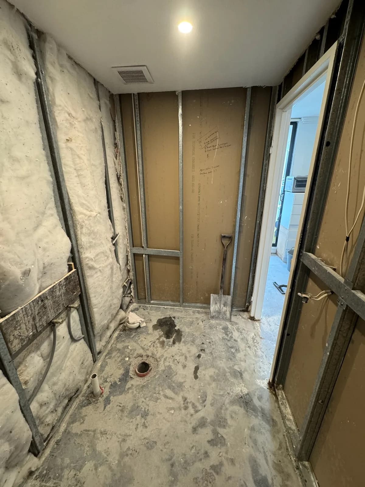 Bathroom stripped back to the frame with old insulation exposed