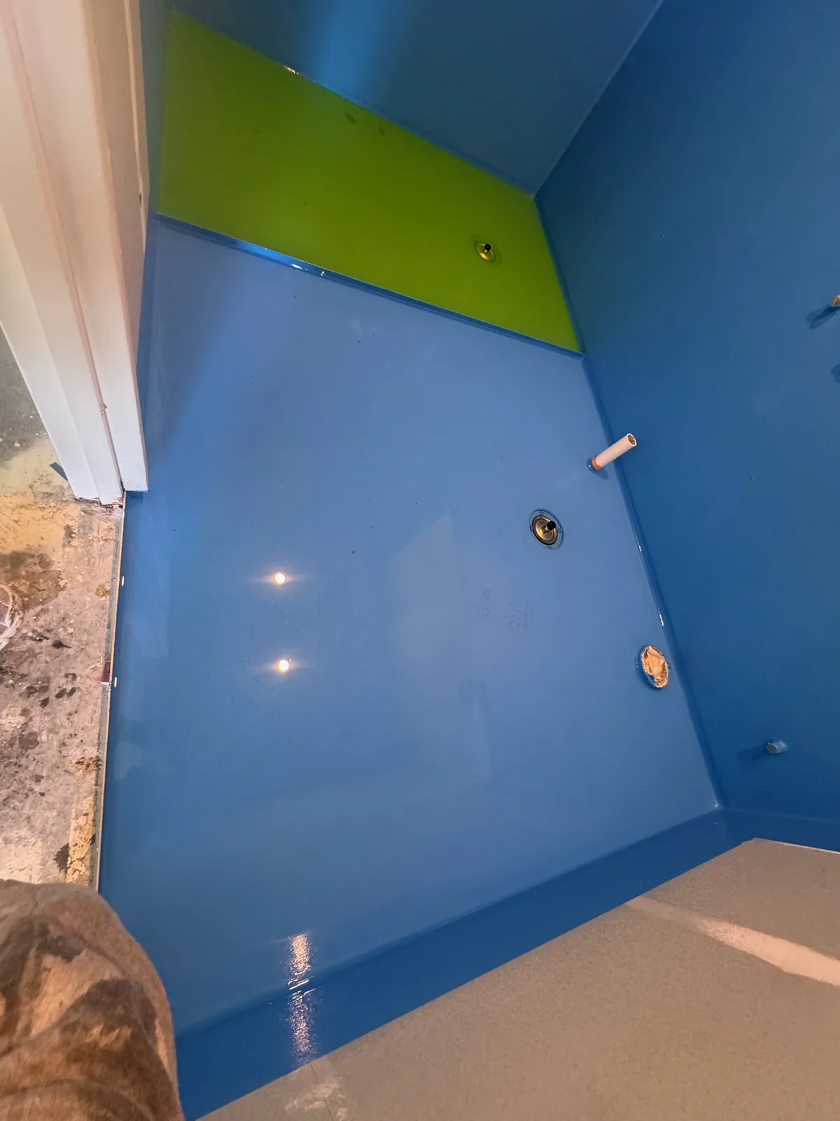 Close view of waterproofing membrane detailed around a tap penetration and wall junction