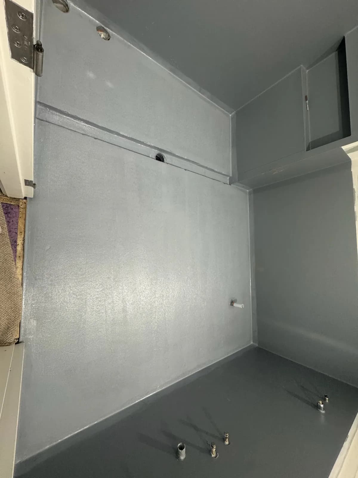 Waterproofing membrane covering bathroom walls to full height above the shower